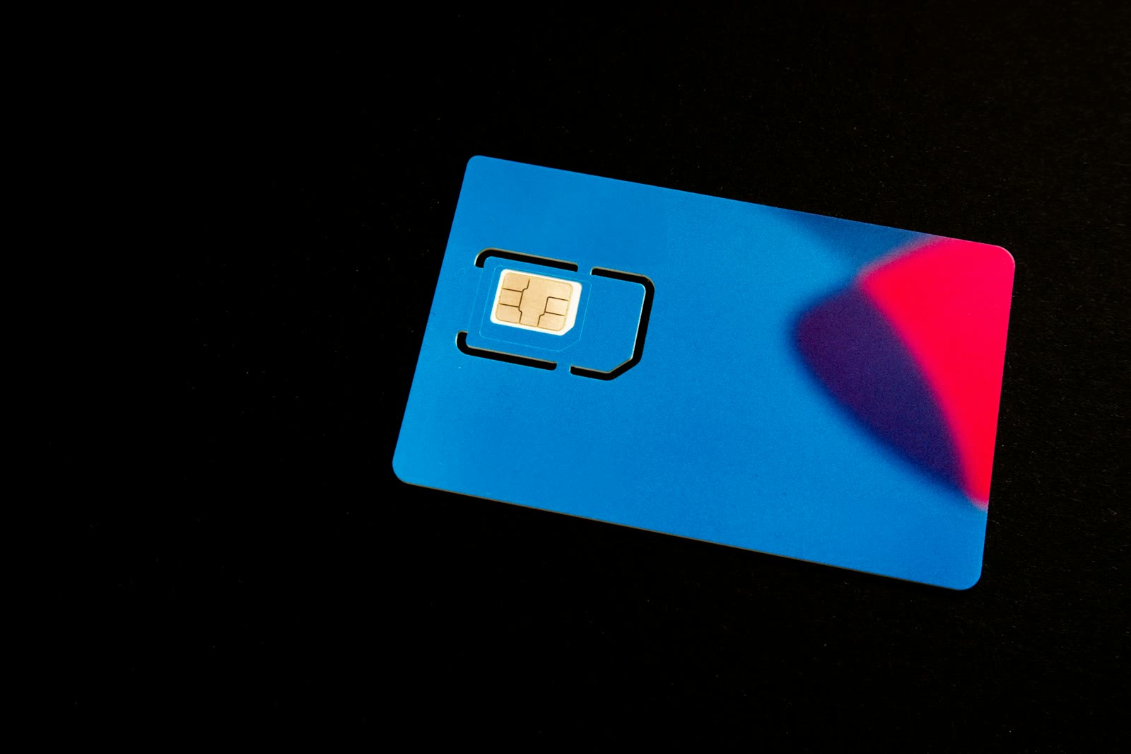 A SIM card on a dark surface - Moose Mobile and Swoop customers need new SIMs for the Vodafone network move