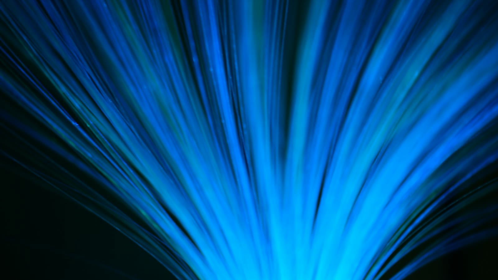Blue fibre optic cables radiating outward - NBN wholesale price rises are flowing through to retail plans